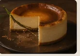 slice of basque cheesecake on a dark plate