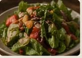 fresh salad with tomatoes greens and house dressing